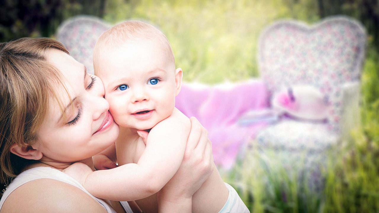 Mother holding baby in soft, natural light